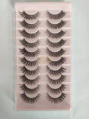 Set of false eyelashes on a pink tray with a white background