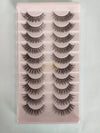Set of false eyelashes on a pink tray with a white background